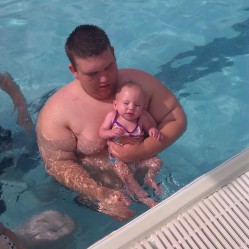 Drew helping Molly swim